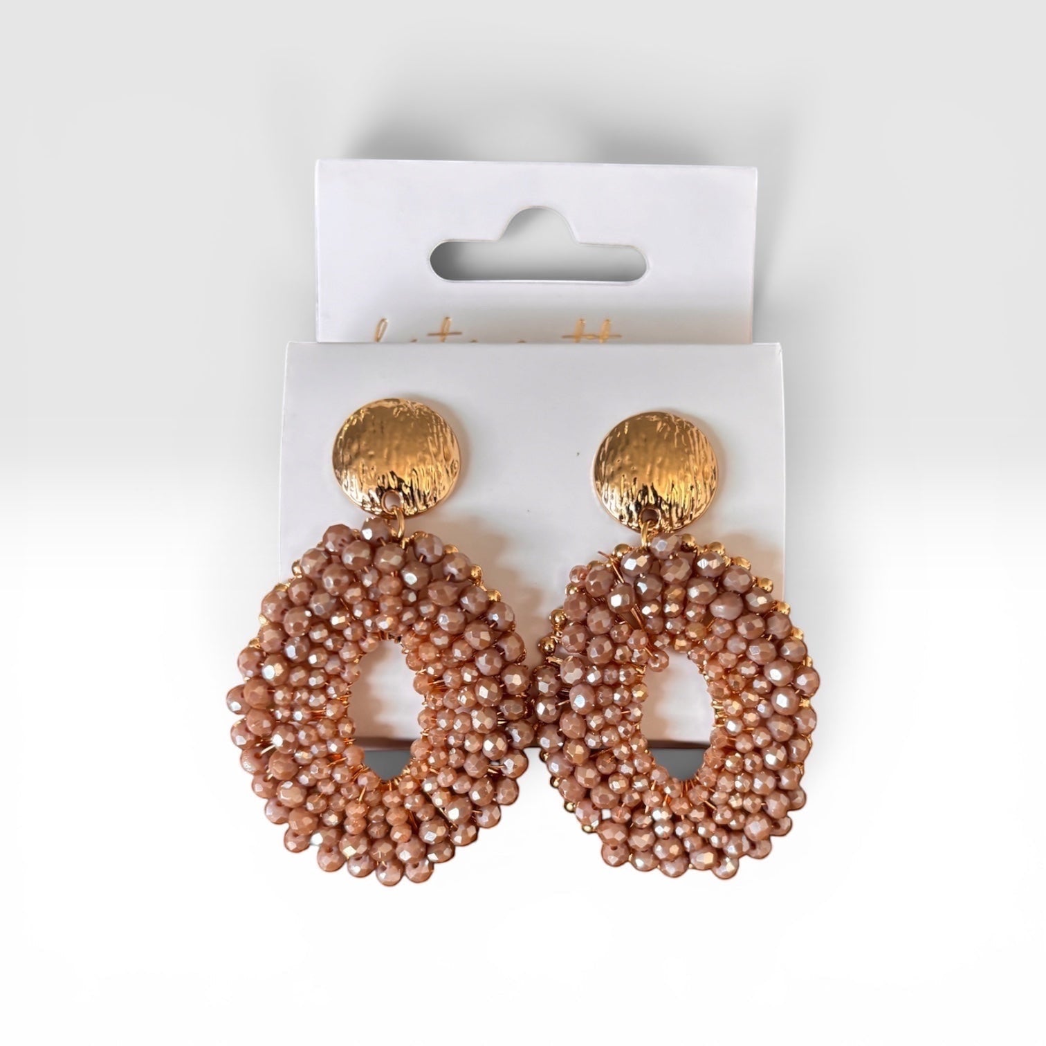 Home-Industry South Africa oval statement earrings featuring champagne-toned faceted beads and hammered gold studs.