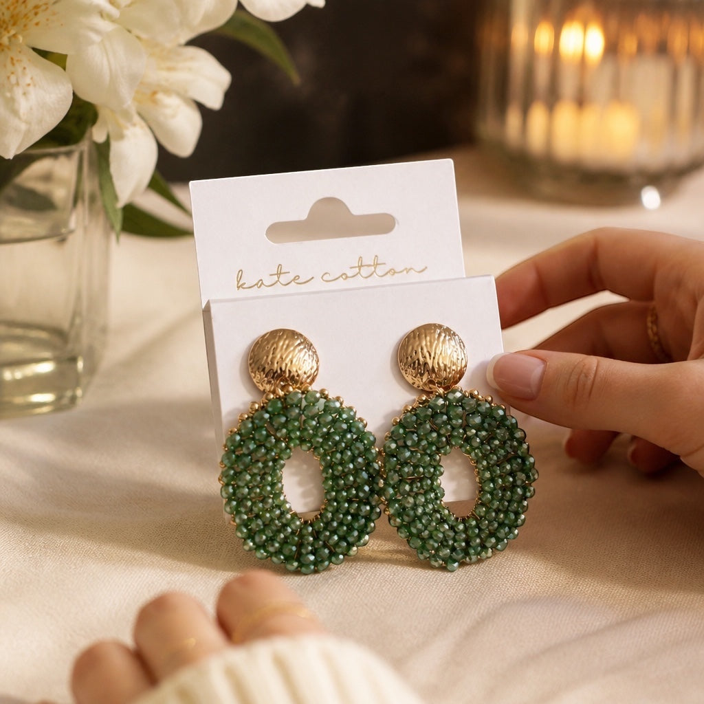 Home-Industry South Africa Halo Sage earrings featuring hand-beaded green crystals and textured gold-tone studs.