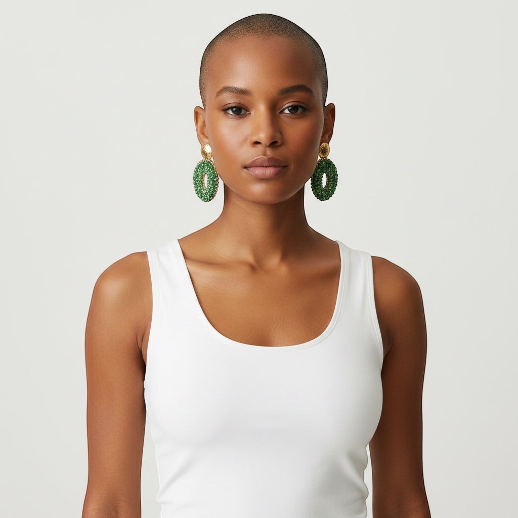 Model wearing Home-Industry South Africa Halo Sage earrings featuring sage green crystal beads and textured gold studs.
