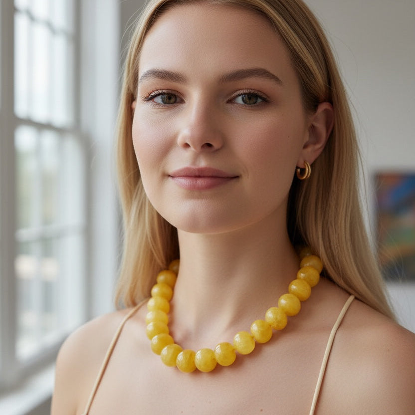 Home-Industry South Africa Chunky yellow beaded statement necklace with polished, rounded beads.